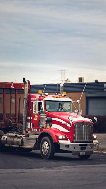 Vibrant red semi truck parked in an industrial area of Montreal, Canada.